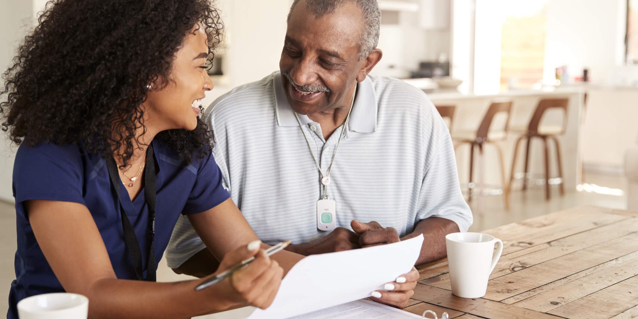 Carer Helping an old man write | Bristol Home Carers