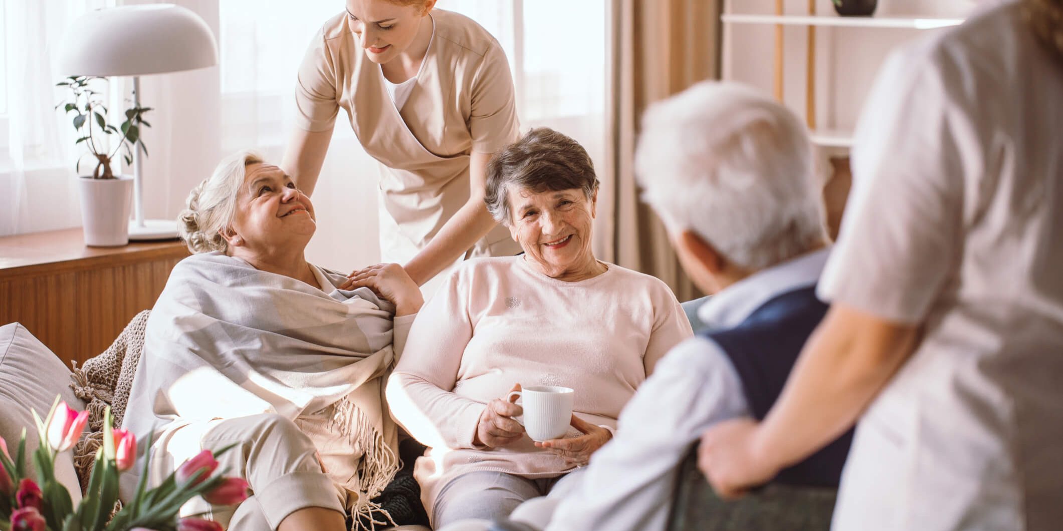 Old Women chatting while their carers take care of them | Bristol Care Providers